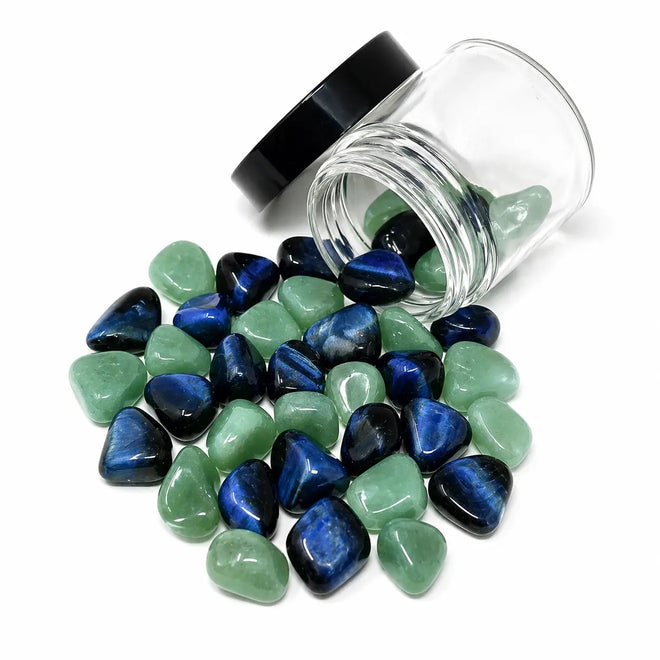 Clarity crystal blend with Blue Tiger's Eye and Green Aventurine stones spilling from a 4oz glass jar for crystal water bottles