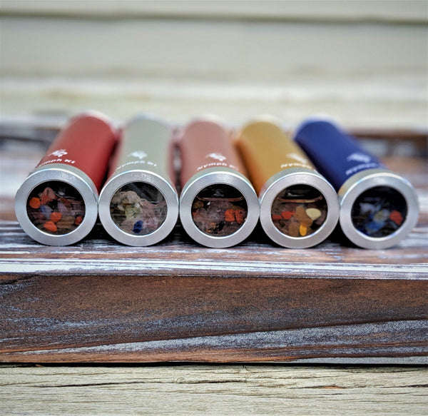 Set of crystal kaleidoscopes including silver, red, gold, blue, and rose barrels showing the crystals.