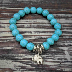 Elephant bracelet with turquoise beads and silver elephant charm symbolizing strength and wisdom.
