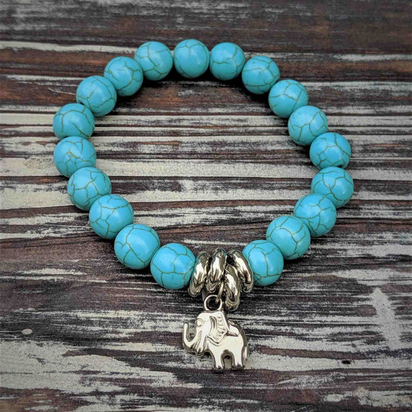 Elephant bracelet with turquoise beads and silver elephant charm symbolizing strength and wisdom.
