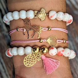 Unicorn Love Bracelet Set featuring gold turtle charm on white beads with pink accents.