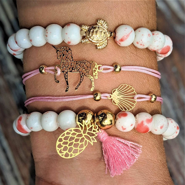 Unicorn Love Bracelet Set featuring gold turtle charm on white beads with pink accents.