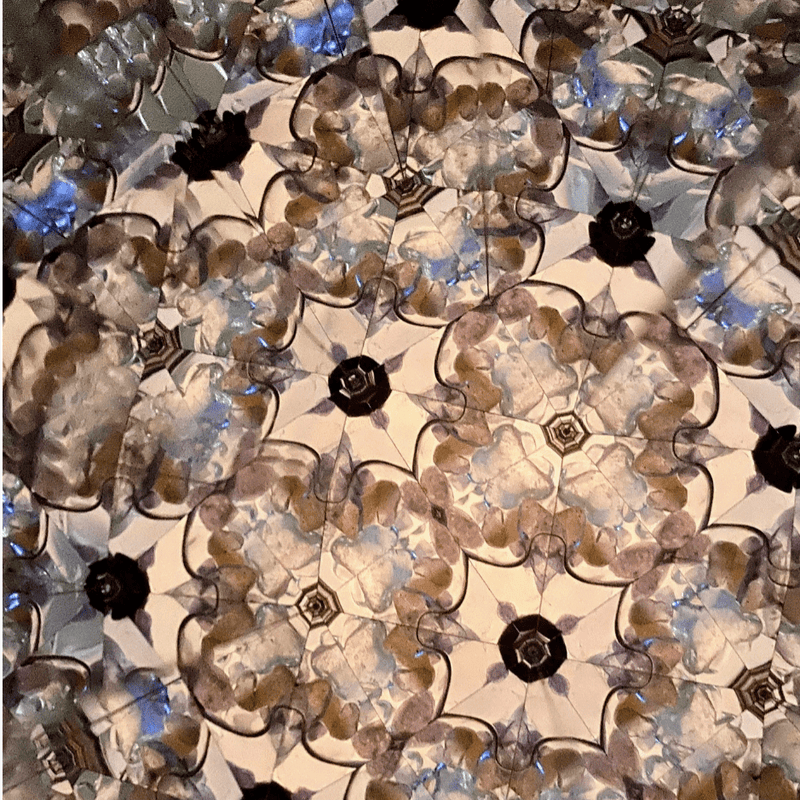Kaleidoscope View – Spiraling crystal pattern in light-reflective hues.- Nymph Ki