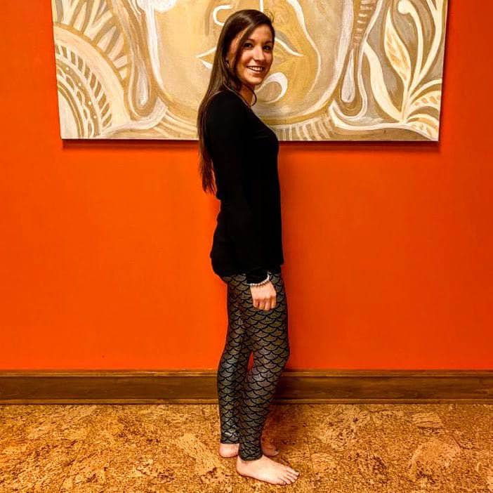 Model in side profile wearing Fish Out of Water Leggings, highlighting iridescent scale texture and flattering fit.
