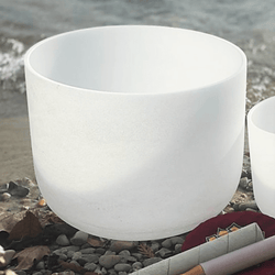 10-inch quartz singing bowl with rubber O-ring and mallet resting on gravel, used for chakra sound healing.