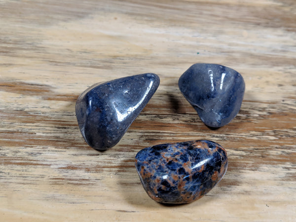  Polished dark blue crystals for the throat chakra, including sodalite and lapis lazuli, promoting communication and self-expression.