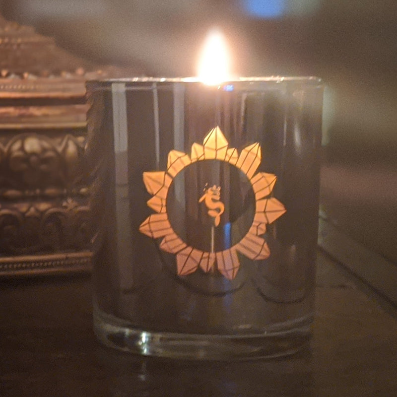 Candle burning gently in low light, styled for meditation or sacred space.