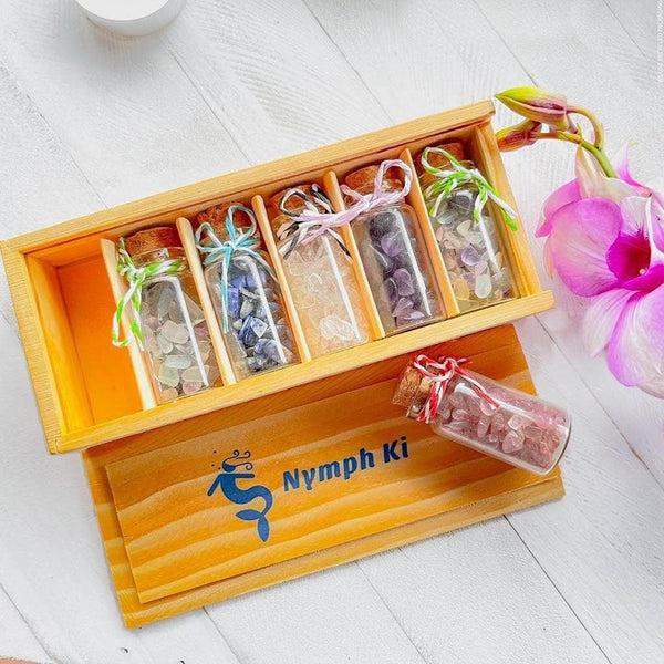 Wooden Nymph Ki box with pocket-sized crystal intention jars for healing, meditation, and ritual energy work.
