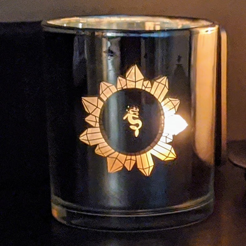  Crystal-infused candle in glossy silver jar with Nymph KI lotus logo.