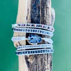 Marble Wrap Bracelet featuring a dark center stone and layers of white, gray, and pink beads wrapped on natural cord – Nymph Ki.