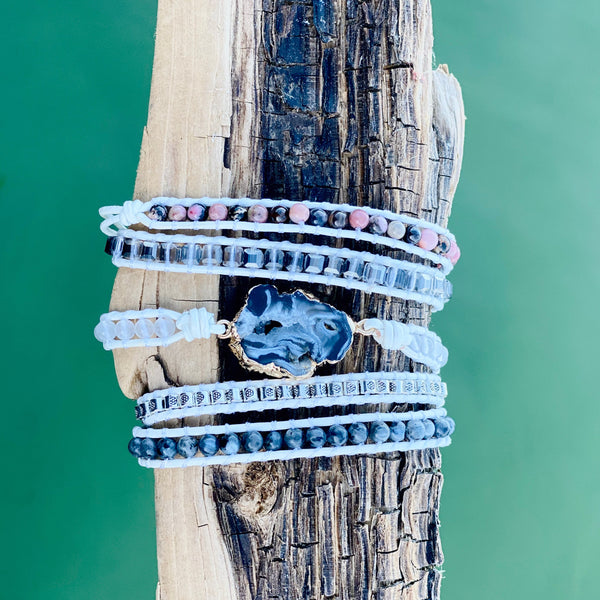 Marble Wrap Bracelet featuring a dark center stone and layers of white, gray, and pink beads wrapped on natural cord – Nymph Ki.
