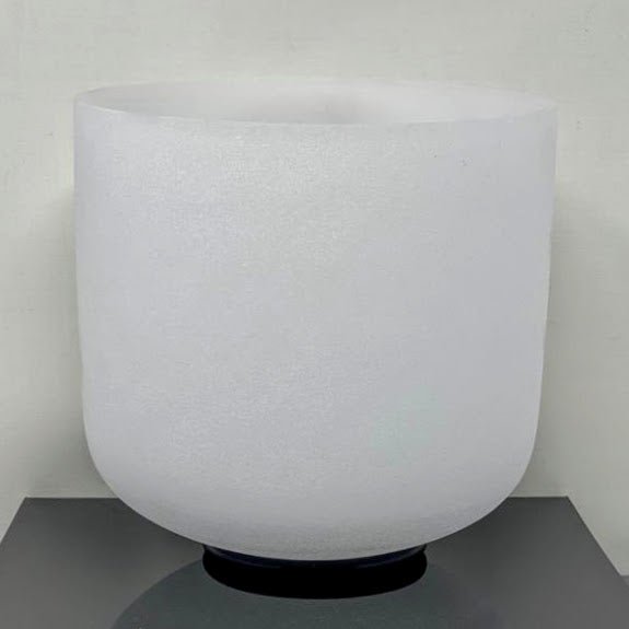 Single quartz crystal singing bowl on a rubber O-ring against a white background.