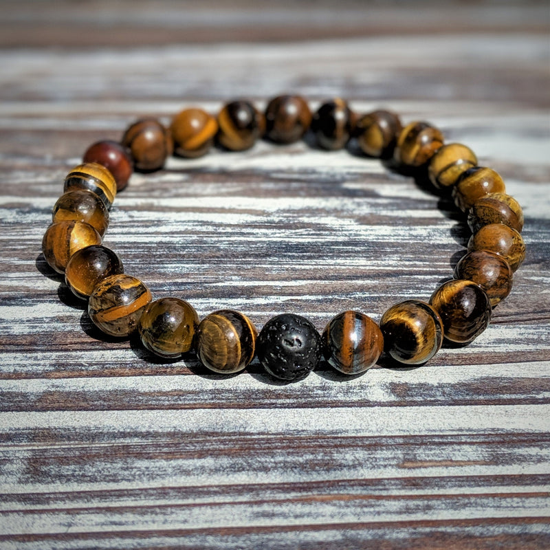  Stretch bracelet with alternating Tiger’s Eye and Lava Rock beads, displayed on rustic wood in natural lighting.