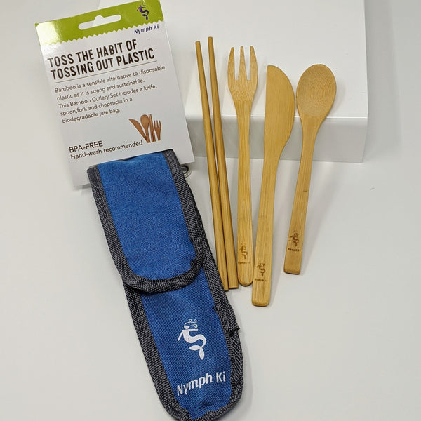 Bamboo utensil set shown in its branded blue travel pouch, displayed with sustainable packaging.