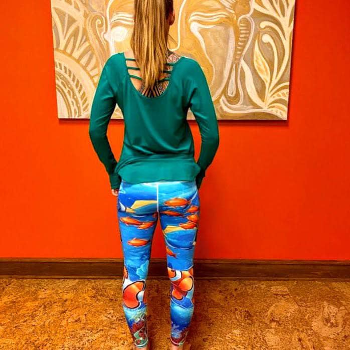Back view of model in Tropical Sea Leggings showing wave-print waistband and undersea pattern placement.
