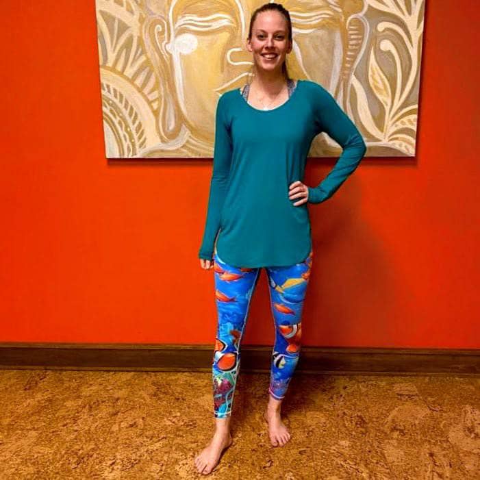 Model wearing Tropical Sea Leggings in a front-facing pose with hand on hip, showing the vibrant ocean life print.
